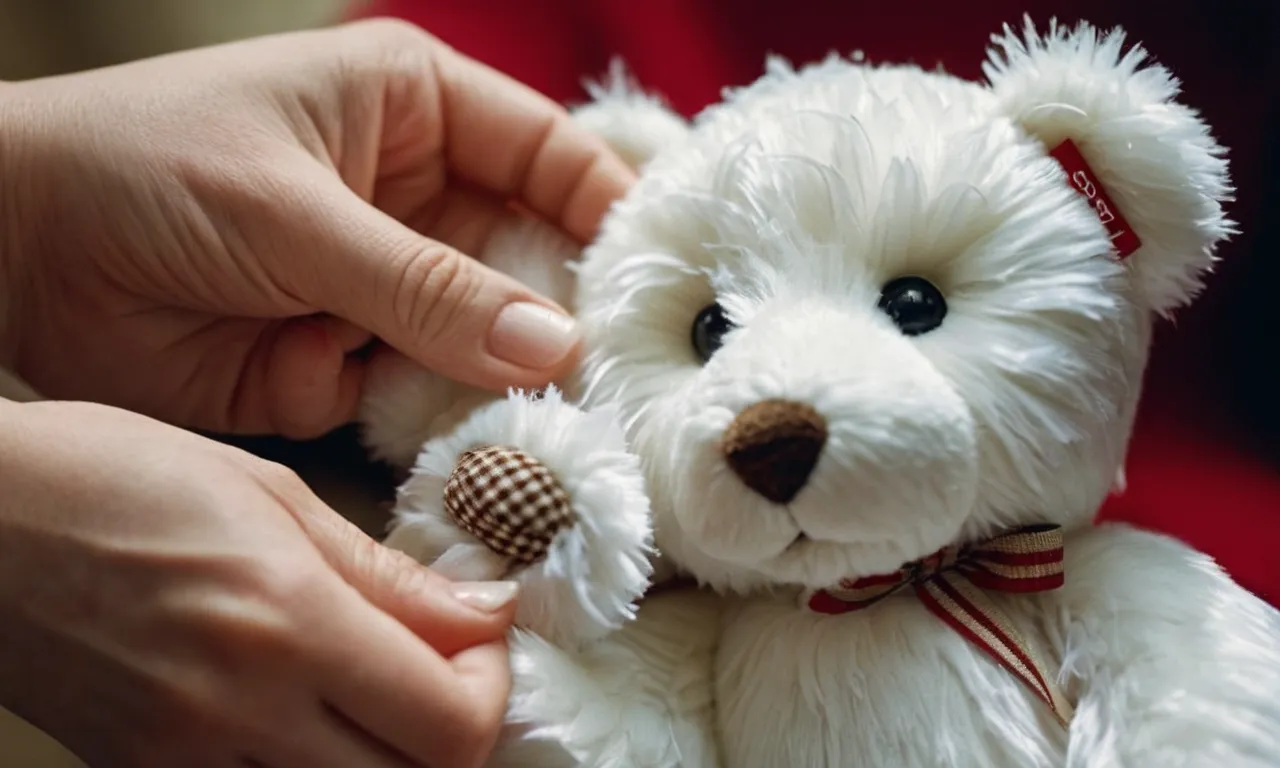 A close-up photograph captures a pair of delicate, white-gloved hands gently wiping the fur of a beloved Steiff stuffed animal with a soft cloth, ensuring its cleanliness and preservation.