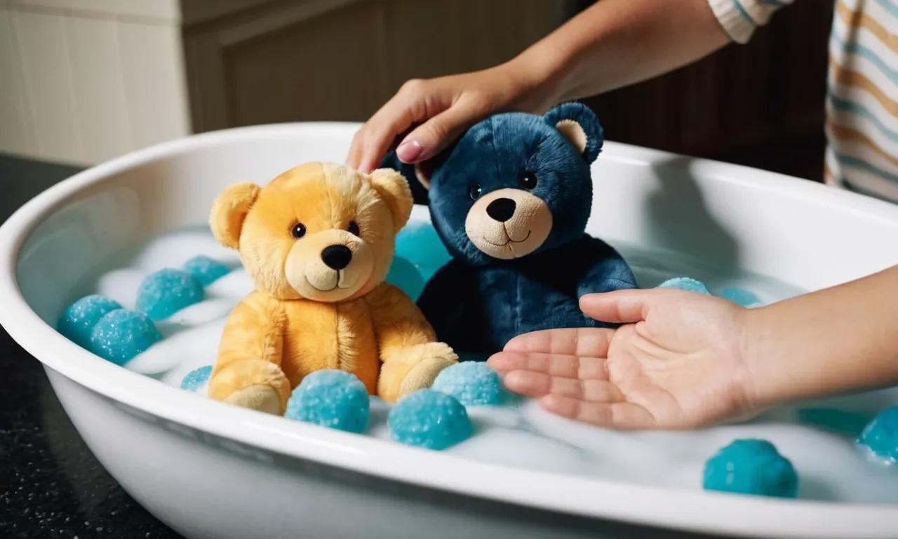 A close-up photo capturing a pair of hands gently washing a colorful polyester stuffed animal in a basin filled with soapy water, showcasing the care and delicacy required for cleaning.
