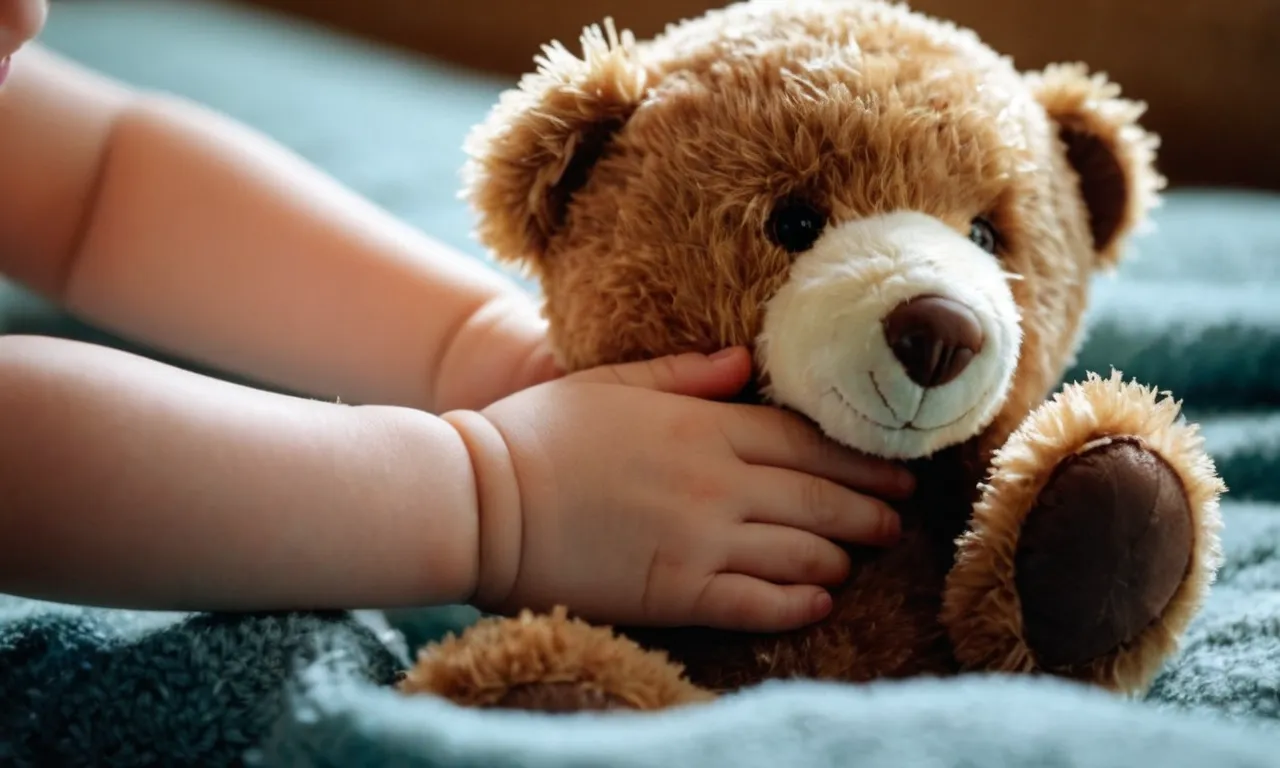 A close-up photo capturing a child's hand tenderly cradling a worn-out teddy bear, symbolizing comfort, innocence, and the enduring emotional connection we seek in these cherished stuffed animals.