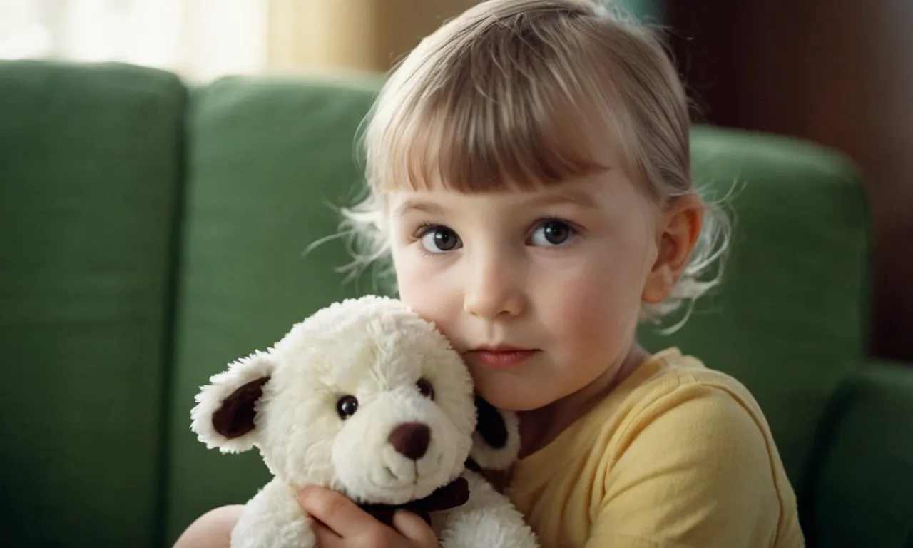 The photo showcases a child, tenderly cradling a beloved stuffed animal, their eyes filled with pure affection and a sense of comfort, capturing the inexplicable bond between humans and their cherished companions.